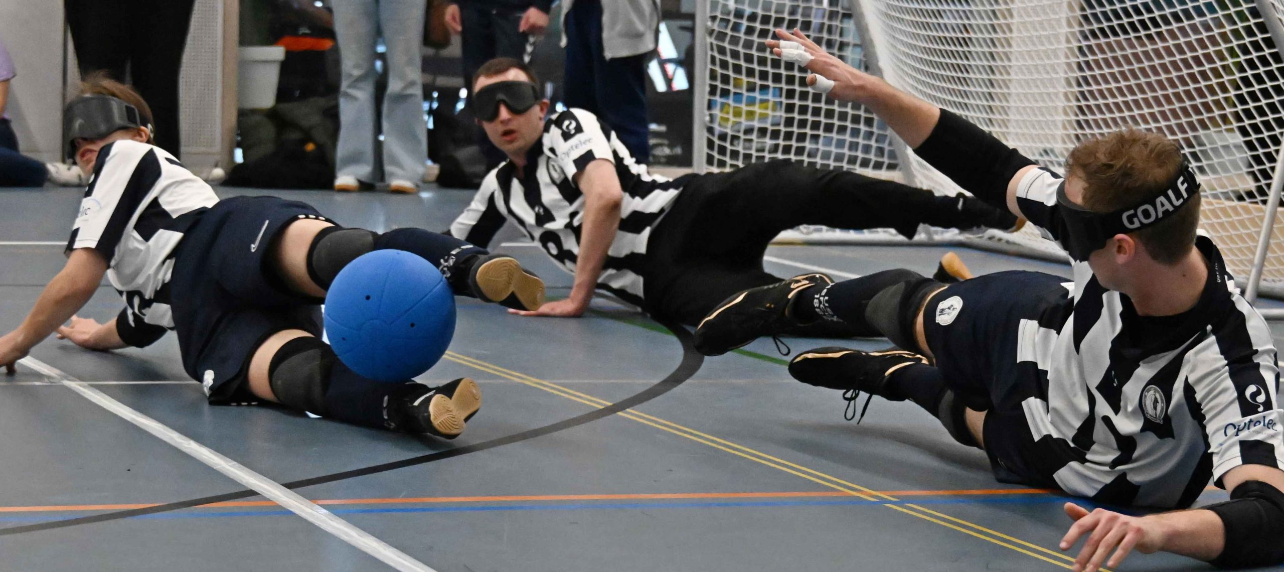 3 people playing goalball.